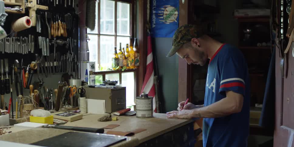 A man is working with a tool in a shop
