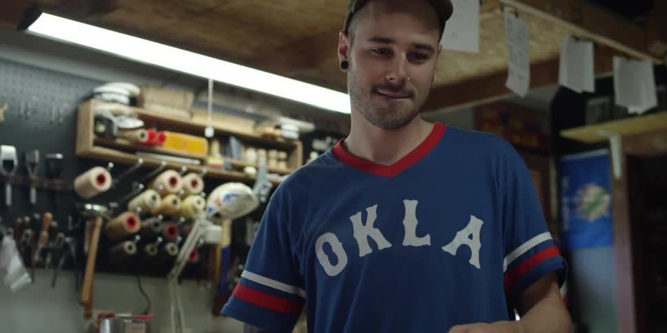 A man in a blue shirt works in a workshop