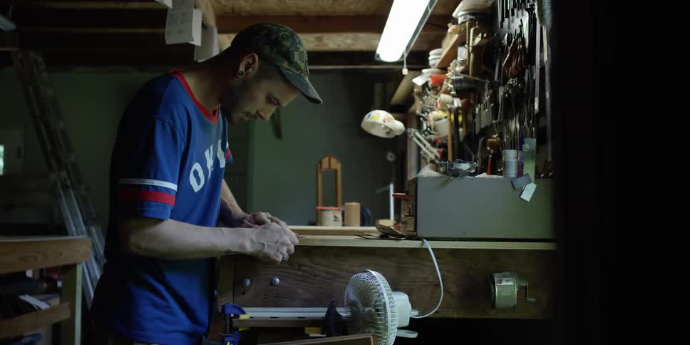 A man is working on a bench