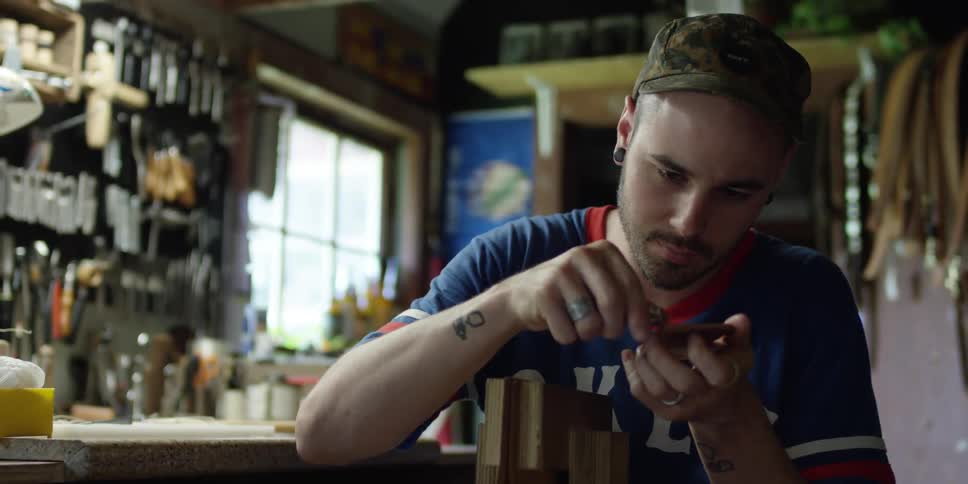 A man uses a lighter on an object