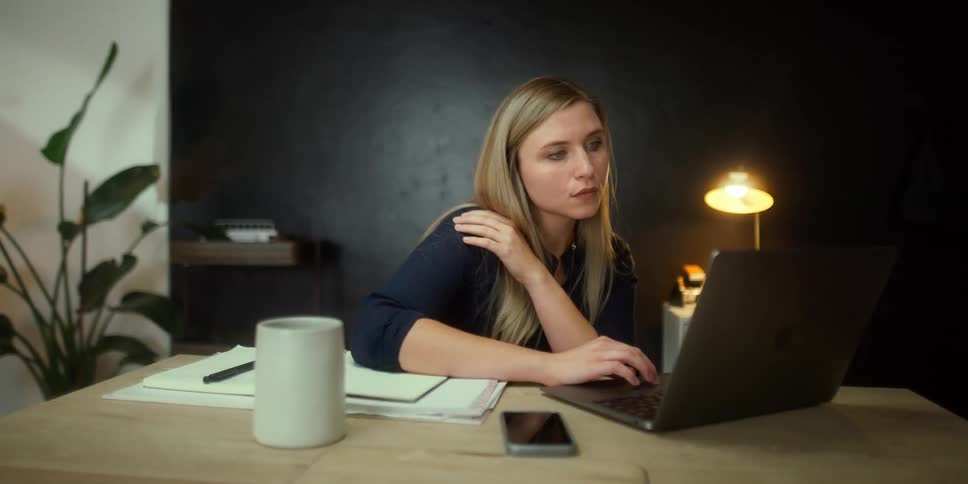 A woman at a desk using a computer