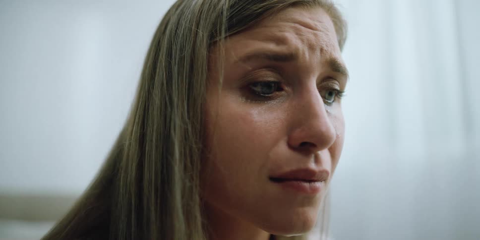 A woman crying in a room