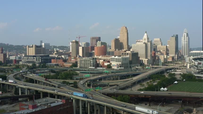 Aerial view of city skyline with vehicles driving on highways