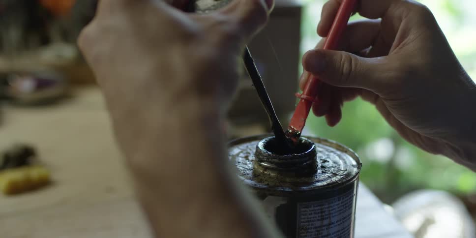 A person mixes glue from a can