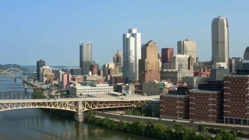 Traffic speeds along a highway that runs between a river and downtown