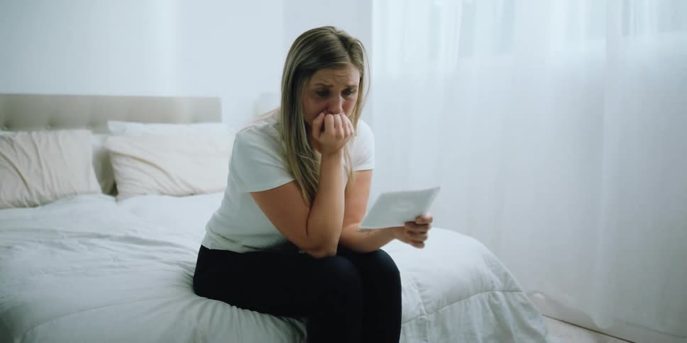 Woman sitting on bed