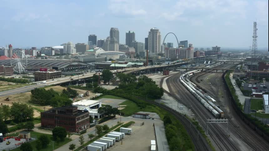 Several train tracks go through a large city