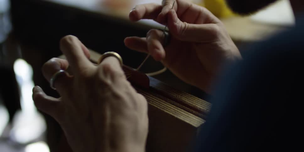 A man ties a knot with string