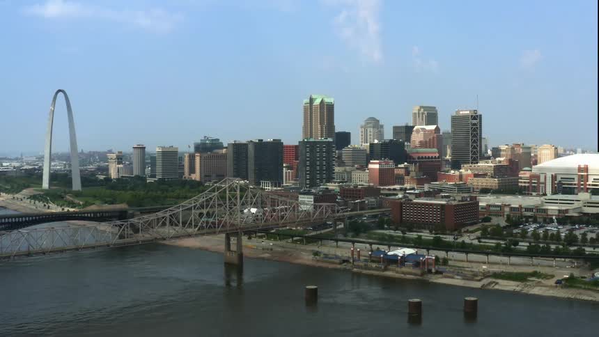 A metropolis alongside a river during the day