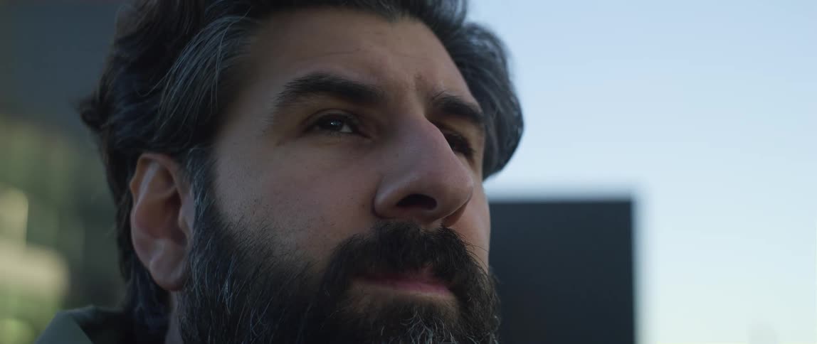A man is looking around at the buildings