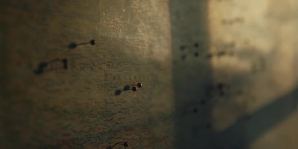 Pushpins are stuck into a wall