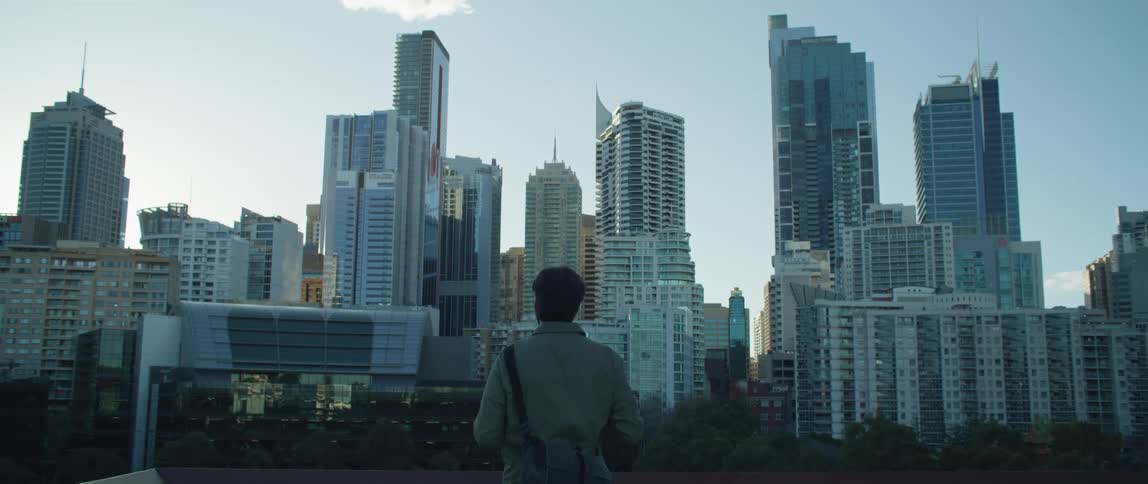 A man is looking out over the city