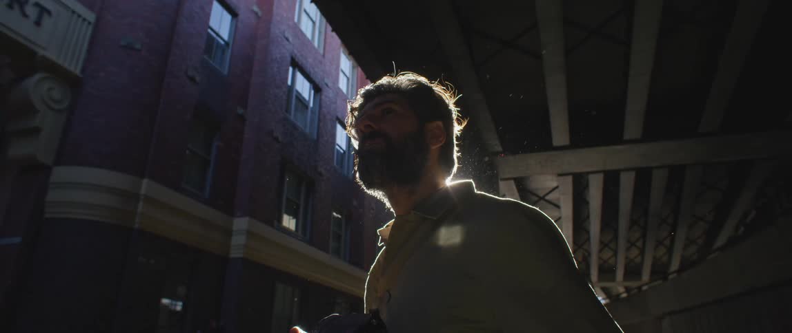 A man taking photos with a camera outdoors at night