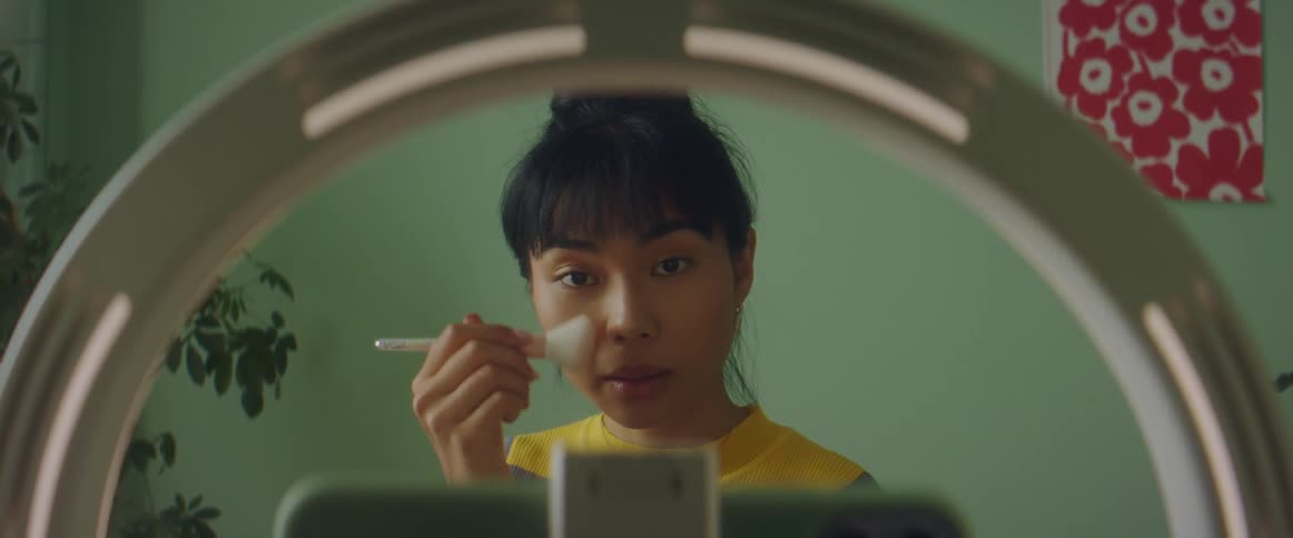 Woman putting on makeup
