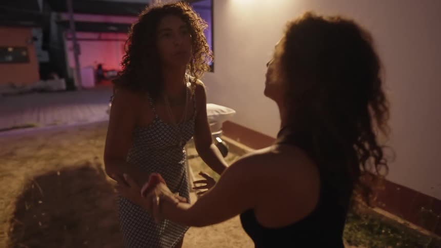 Two sisters argue and shove each other outside a hospital