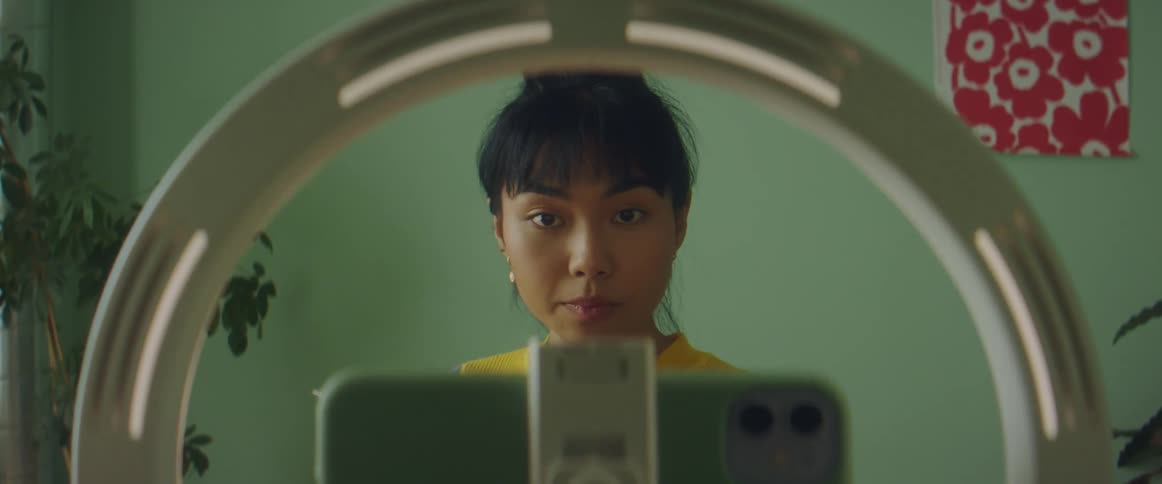 A woman putting on makeup in a room