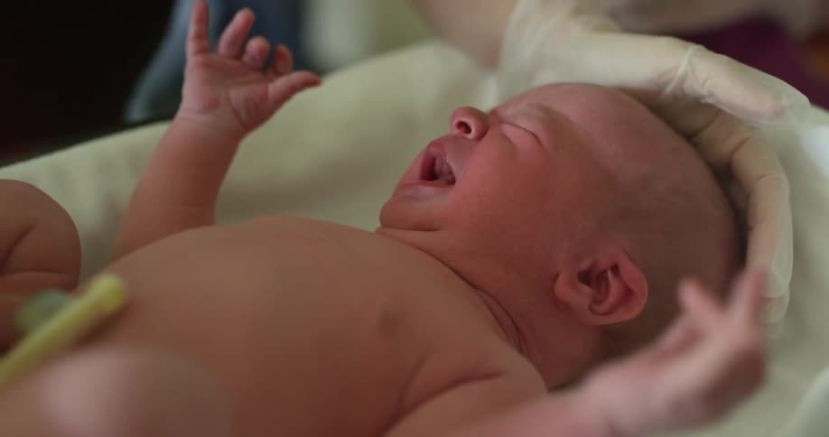 A nurse tending to a newborn