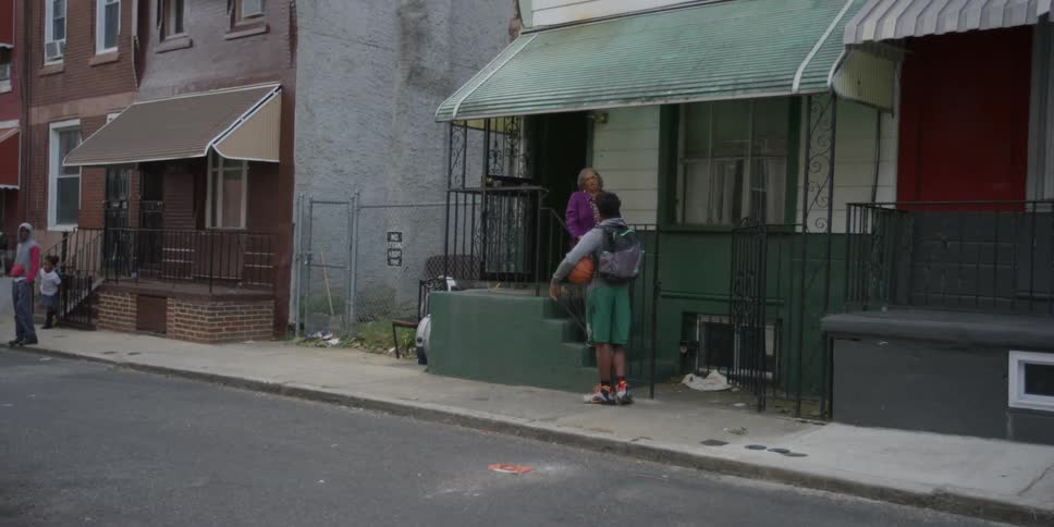 A man is talking to a woman on some steps