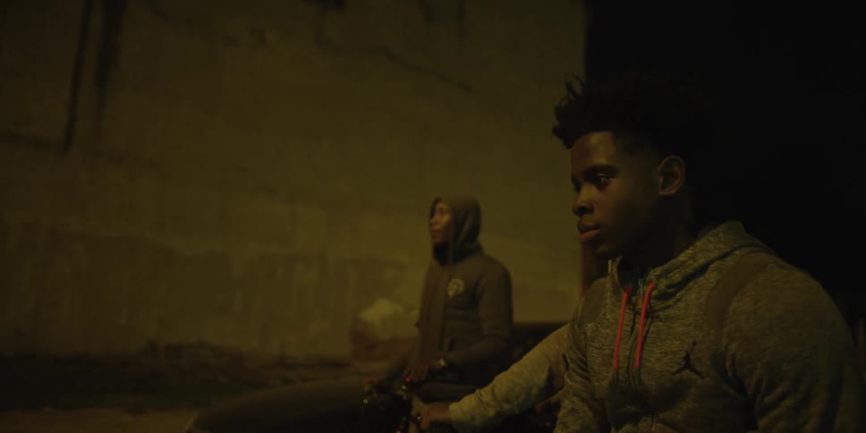 Men are standing outside at night