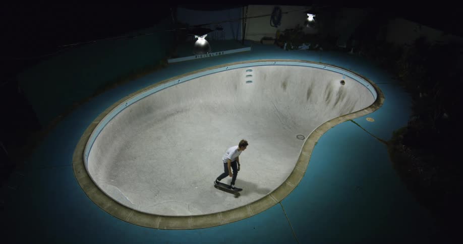 Man rides his skateboard on an indoor ramp