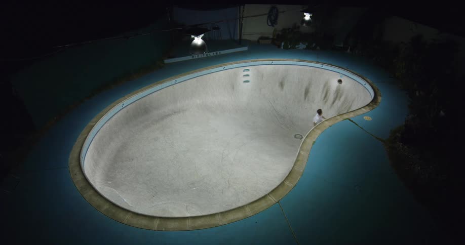 A man is skateboarding in the pool
