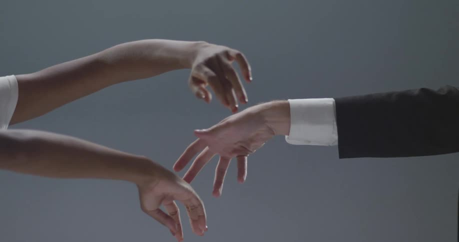Man and woman stretch out their arms gesturing and briefly touching each other