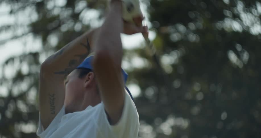 A golfer swings and looks to see where the ball landed