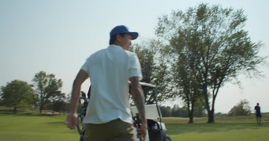 A man that is playing golf on a golf course