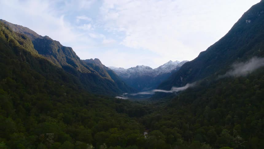A stream of water flows from a mountain valley into a lake