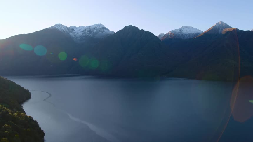 A wide river between mountain ridges during the day