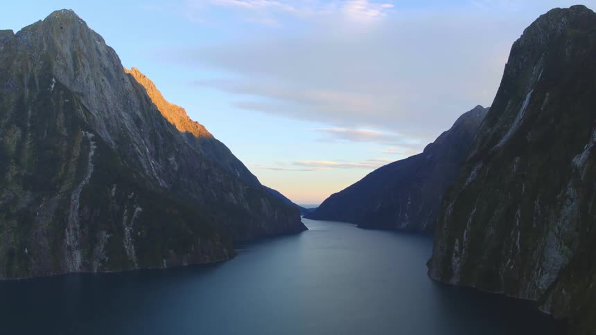 Lake between mountains under a cloudy sky