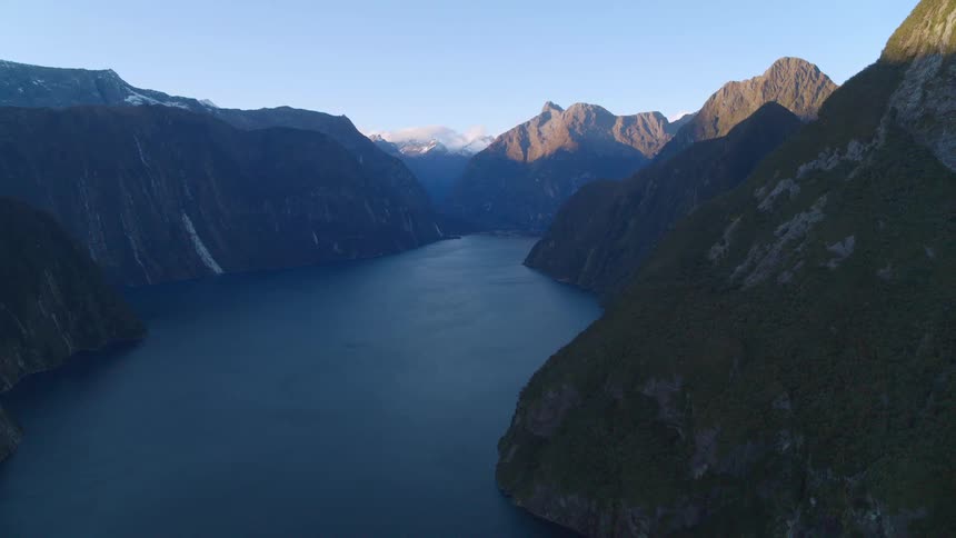 A lake surrounded by mountains under a clear sky