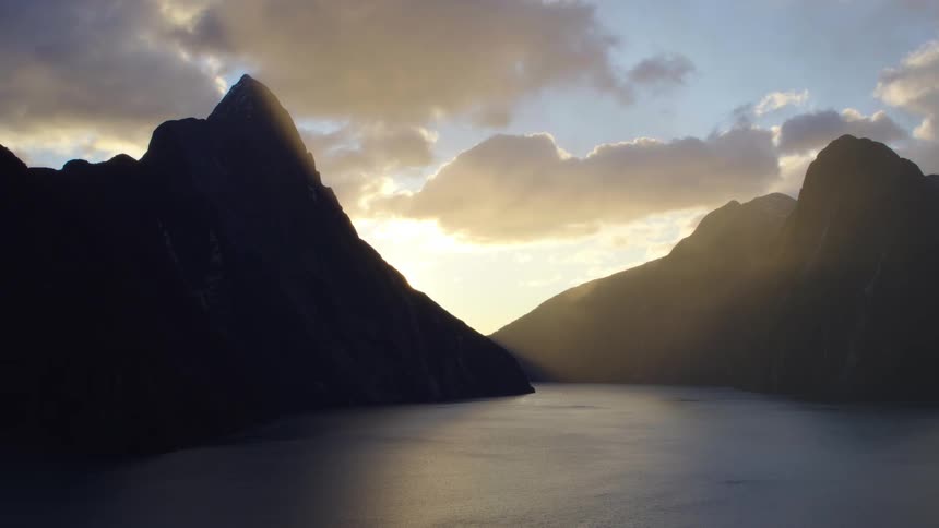 The sun is rising behind the mountains
