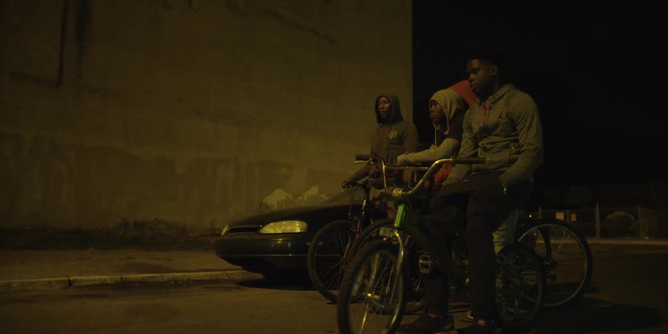A group of kids on bikes at night