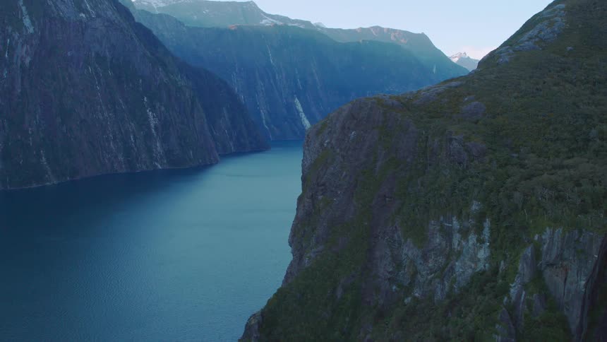 Boat travels on the river between the mountains