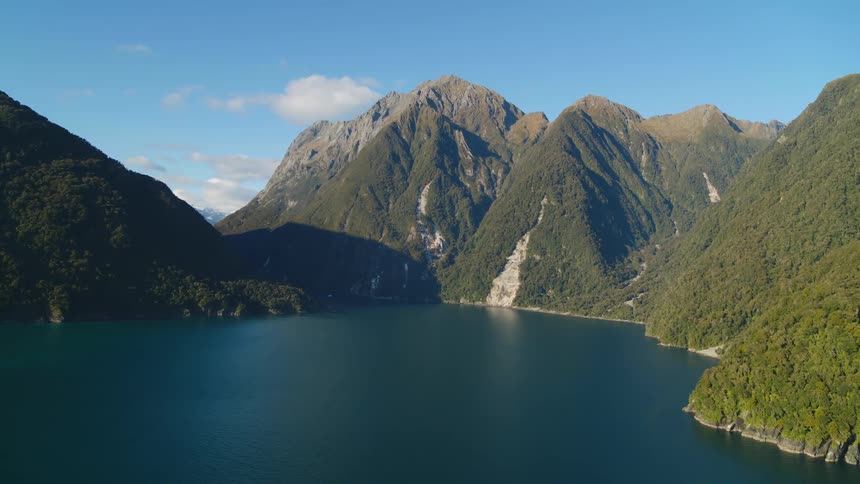 A haze covers the mountains by the water