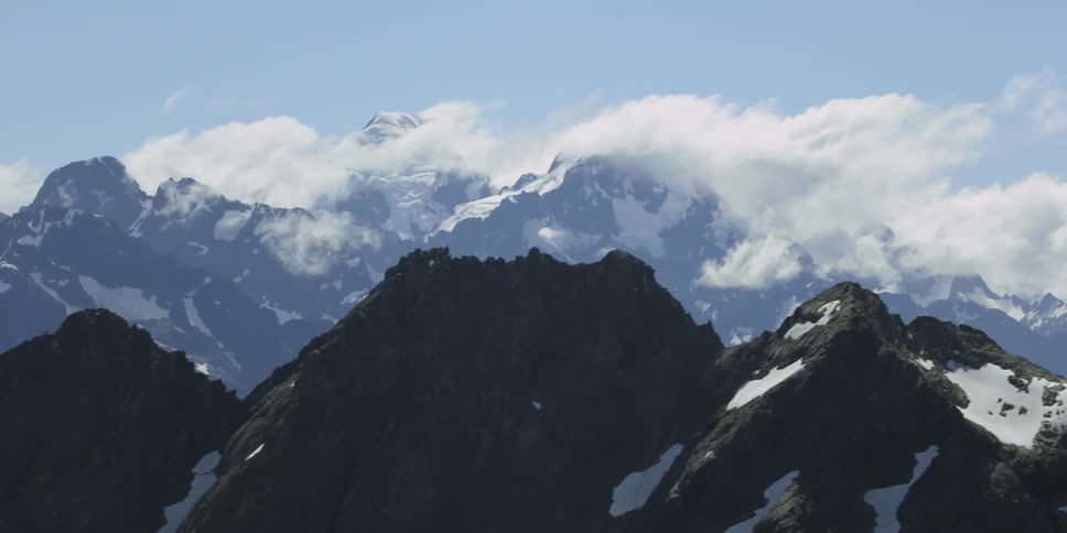 Clouds cover the top of the mountains