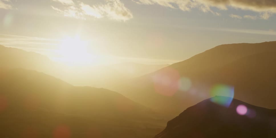 Sunlight shining on a mountain range covered in mist