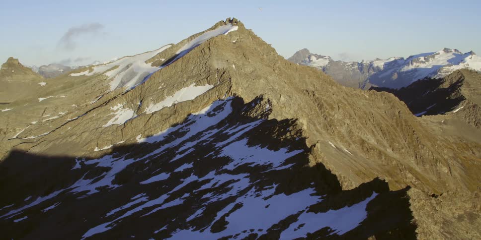 A gray stone mountain ridge during the day
