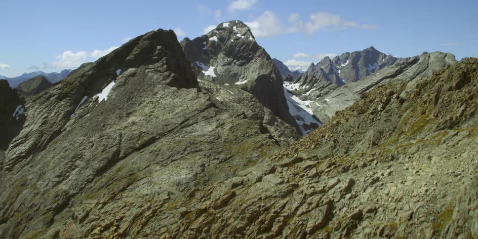 A mountain range with the sky in the background