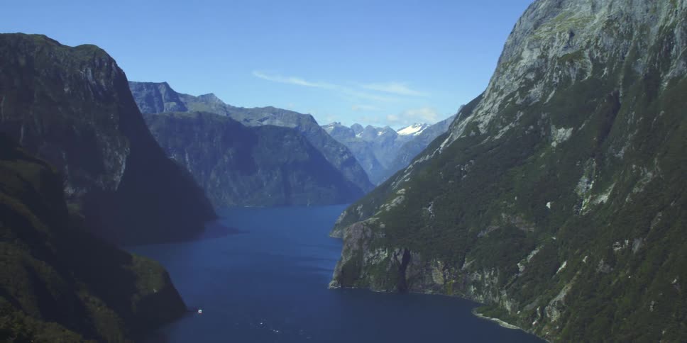 A lake surrounded by mountain ridges covered in vegetation