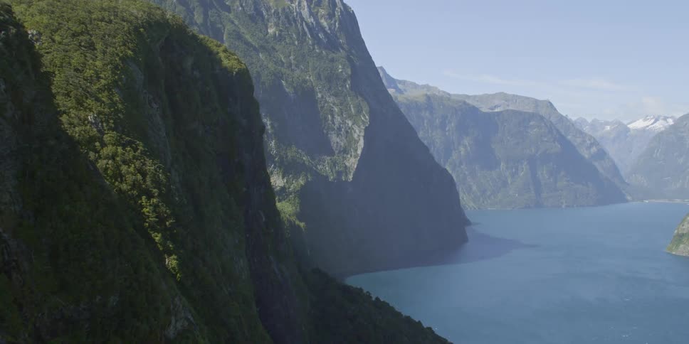 Aerial view of high mountains next to the lake on a sunny day