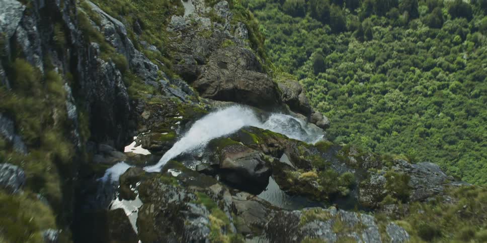 A river between a canyon leading to a waterfall
