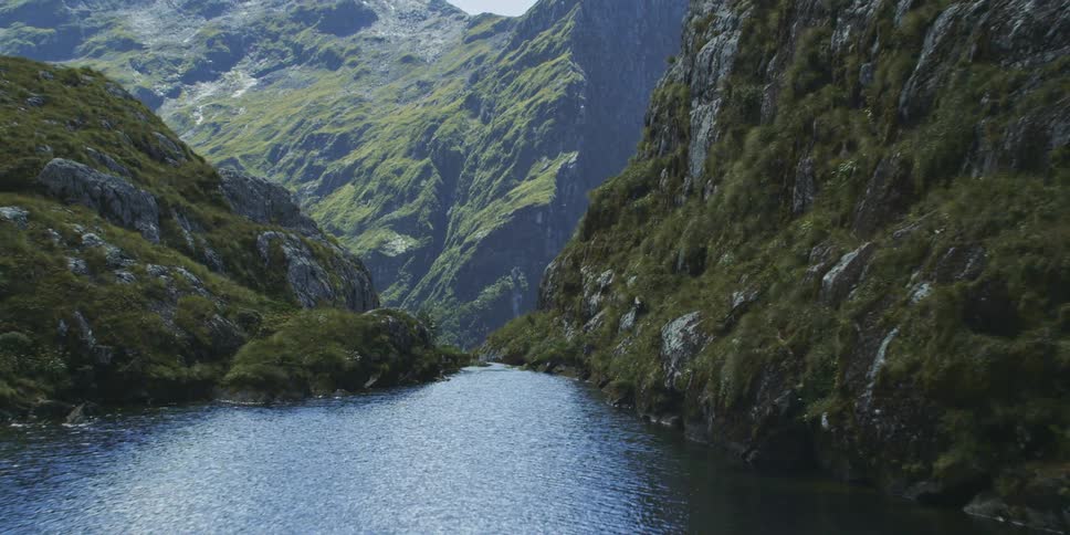 A river flows between hills