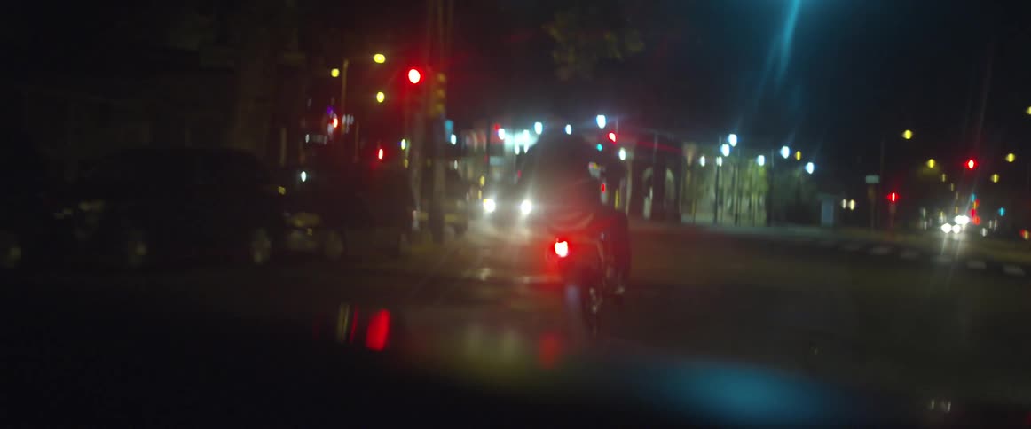 A man does a wheelie on a motorcycle