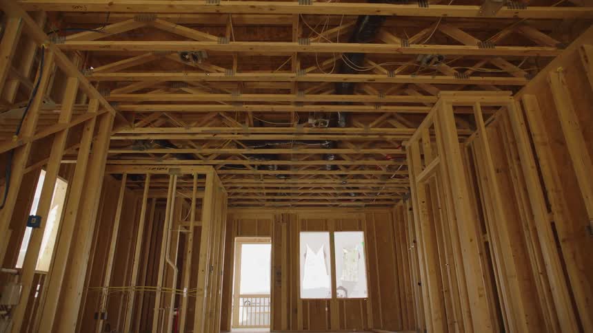 Clothing blows in the breeze outside a window of a building under construction