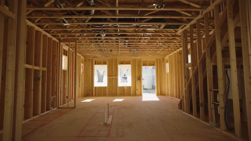 The interior of a building under constructions reveals extensive wooden framing