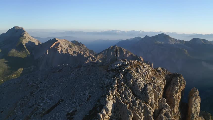 The bare mountain tops of a mountain range poke up through the clouds