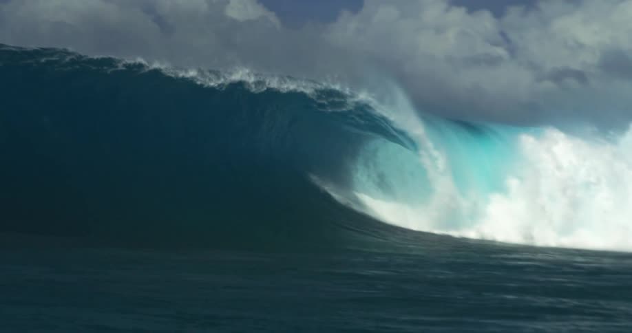 A very large wave crashes down in an ocean