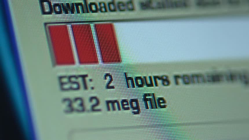 A computer screen displays the progress of data being downloaded